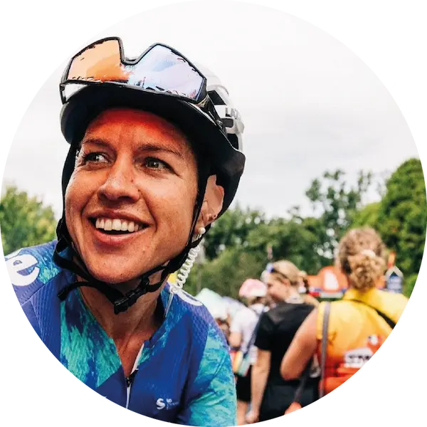 Female cyclist at an event with helmet and sunnies on